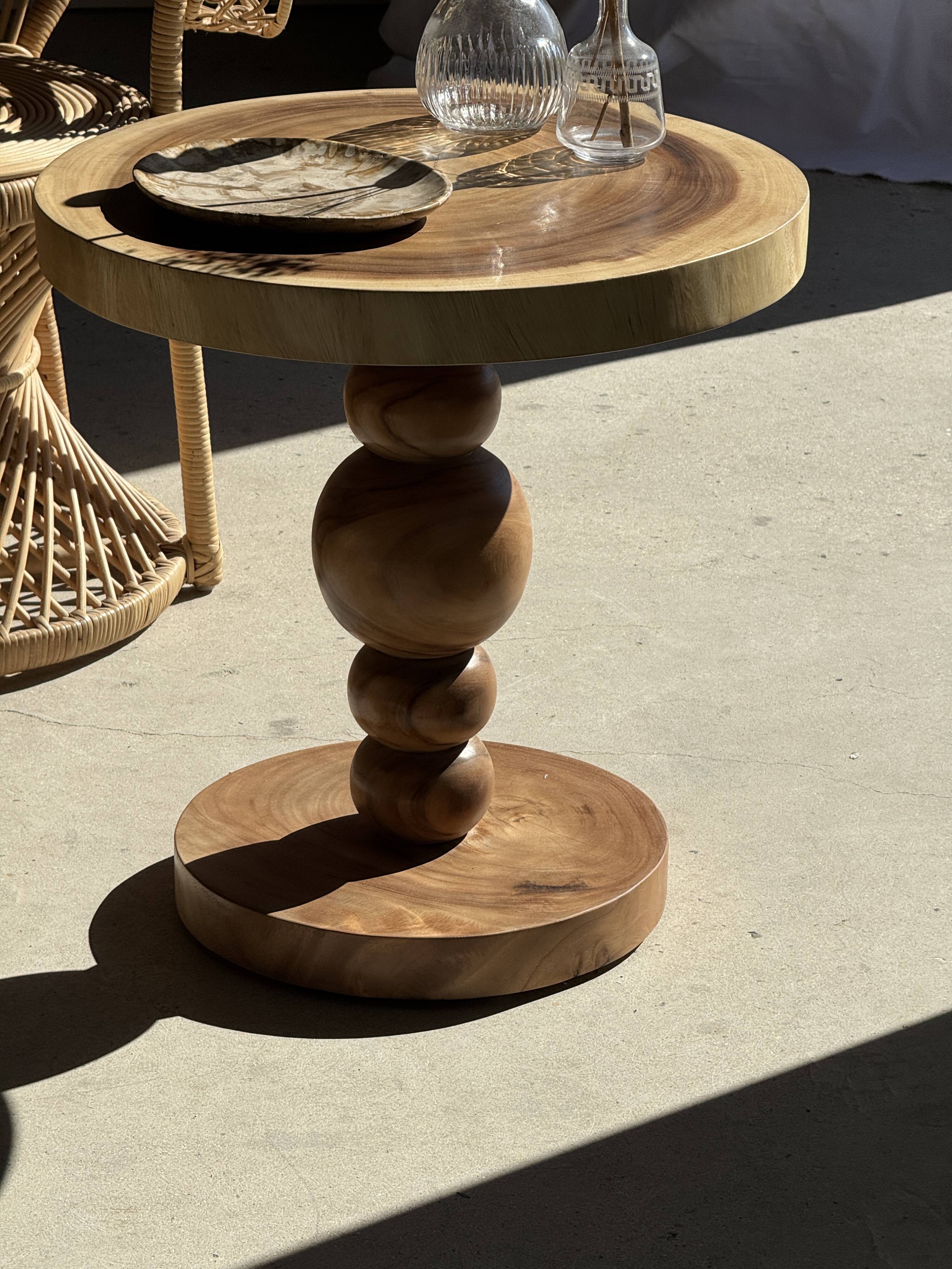 Coffee table in solid suar with central leg and spheres H56.5 D55.5