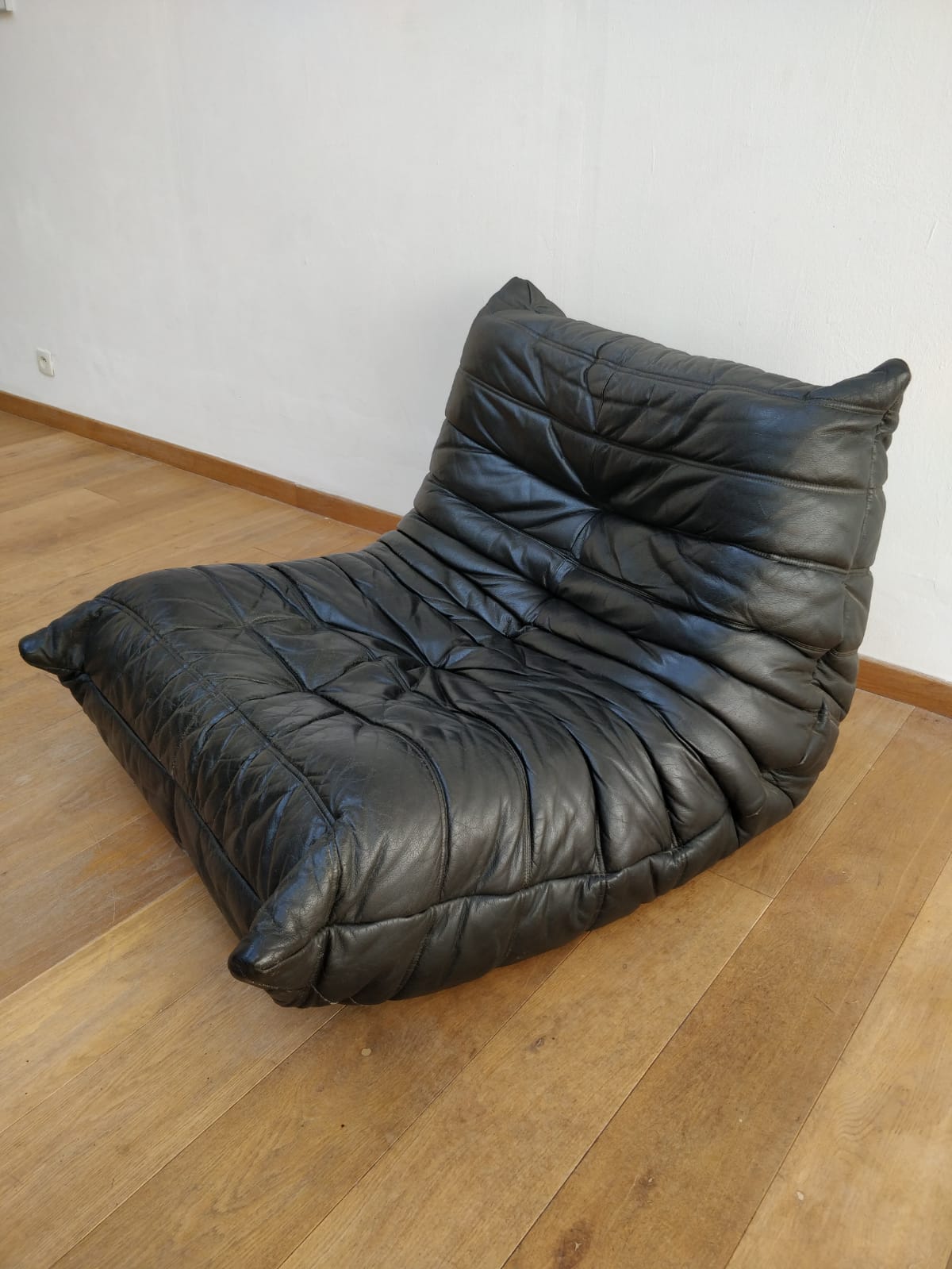 Togo in black leather by Ligne Roset