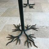 Wrought iron table with tree sculpture and glass top