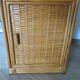 Storage column, wooden bookshelf and woven rattan.