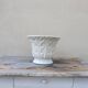 Important white earthenware pot cache with leafy decoration