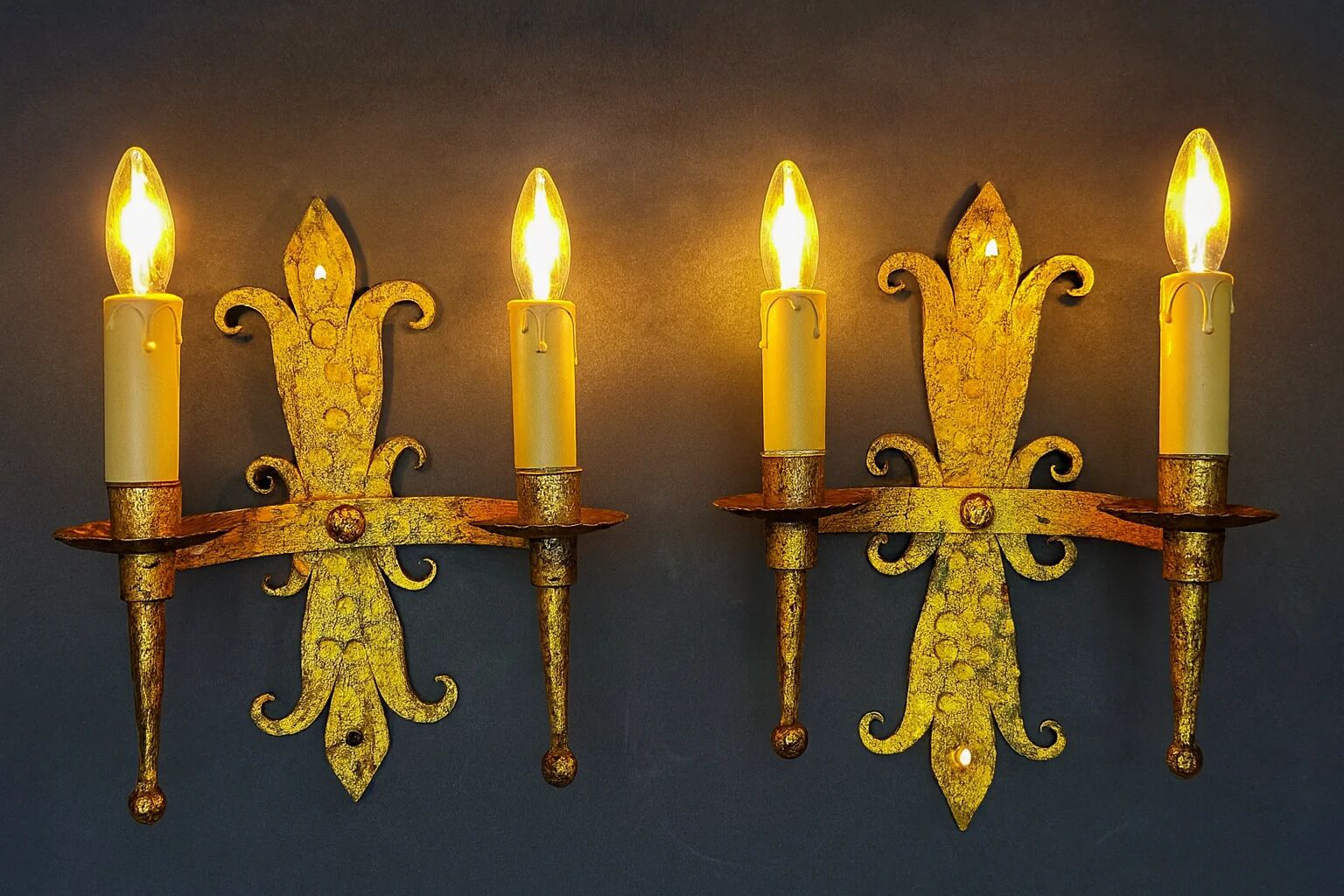 Pair of electrified golden wrought iron gothic wall sconces.