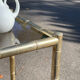 Square faux bamboo pedestal table in gold-plated brass and glass