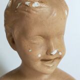 Bust of a small child in ancient plaster