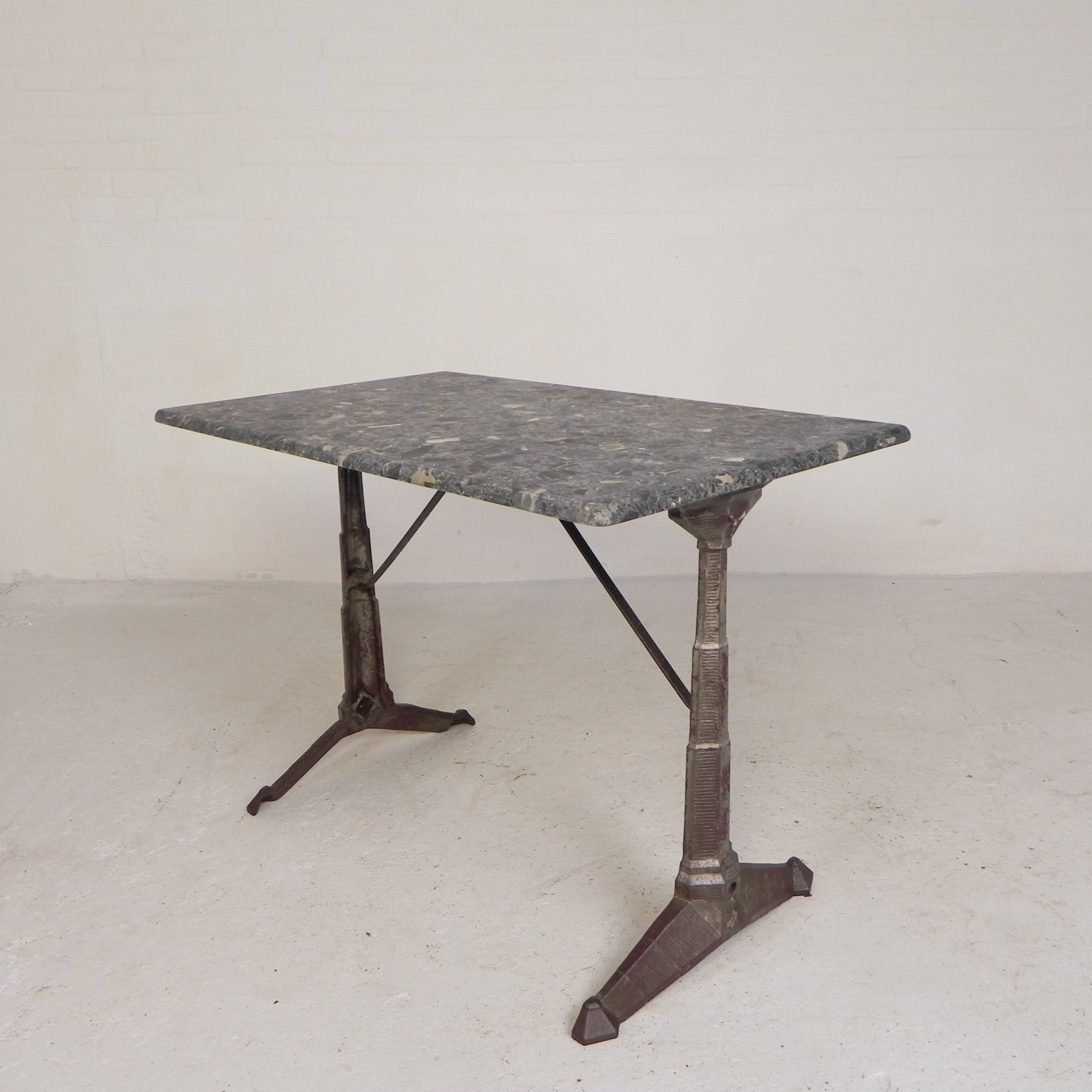 Bistro table with a marble top on a cast iron frame, 1930s.
