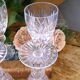 Cut crystal white wine glasses with a slender baluster-shaped stem.