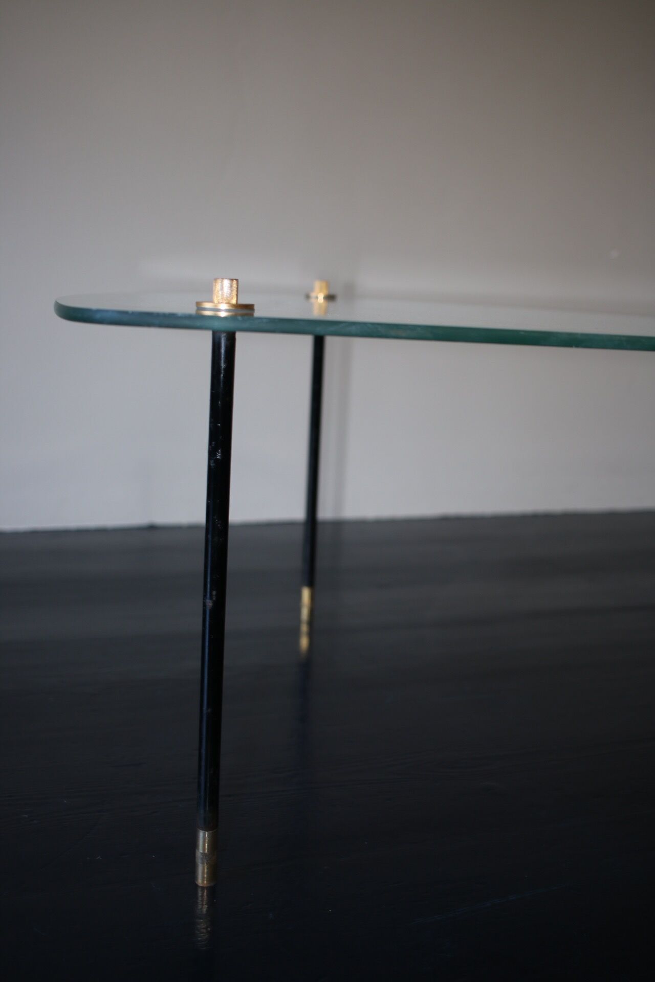 Vintage glass and black-painted brass side table