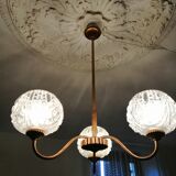 antique chandelier has 3 globes