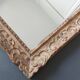 Large Montparnasse rocaille style frame in carved wood mounted in mirror.