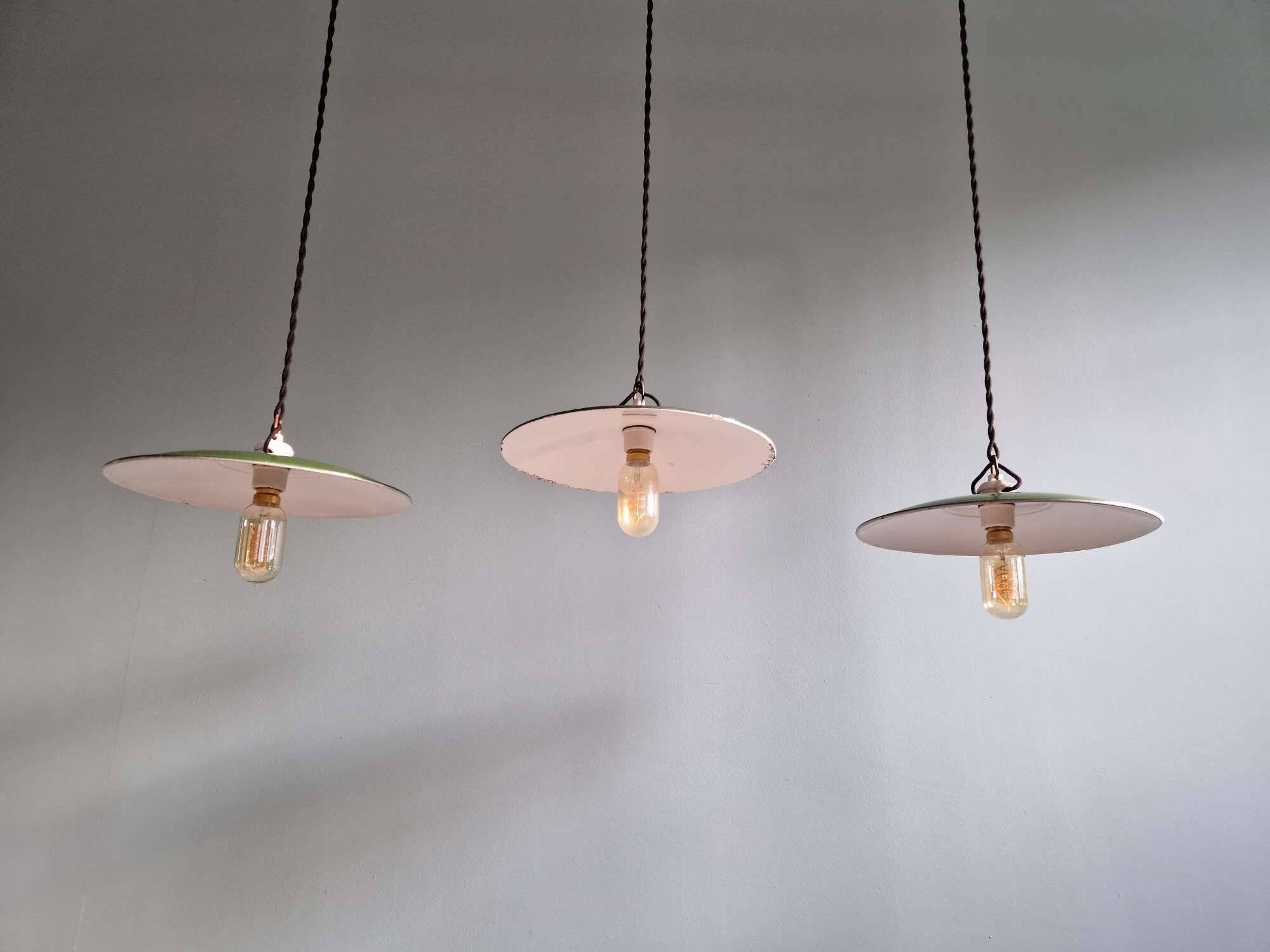 Trio of large industrial suspensions in green enamelled sheet metal.