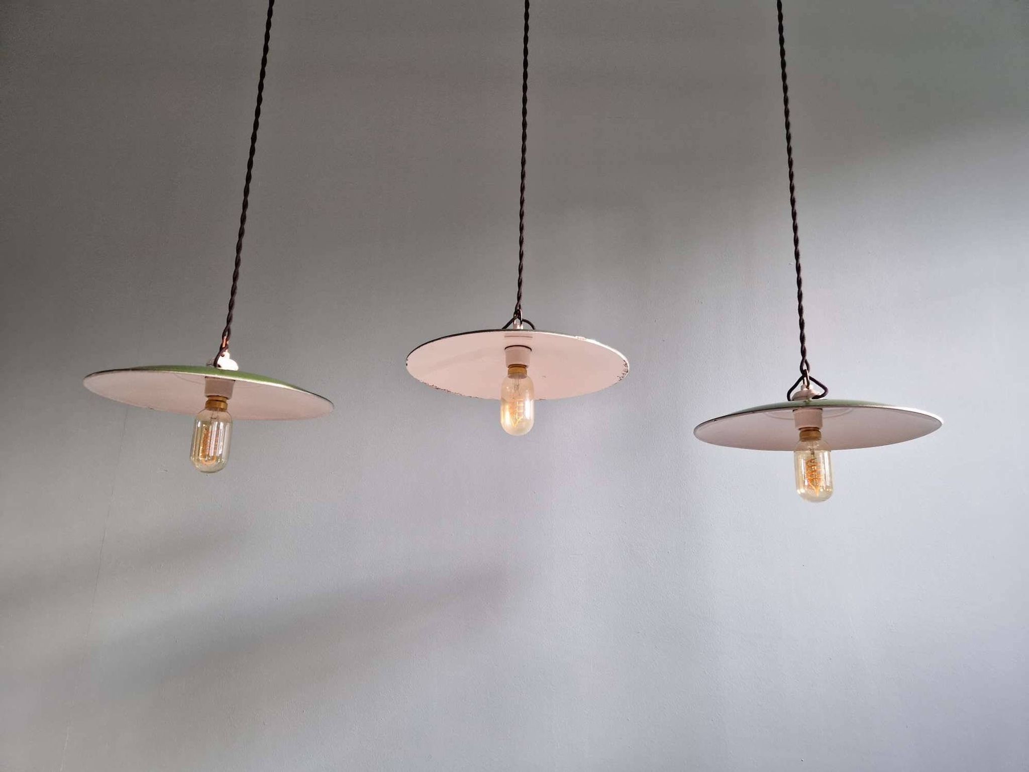 Trio of large industrial suspensions in green enamelled sheet metal.