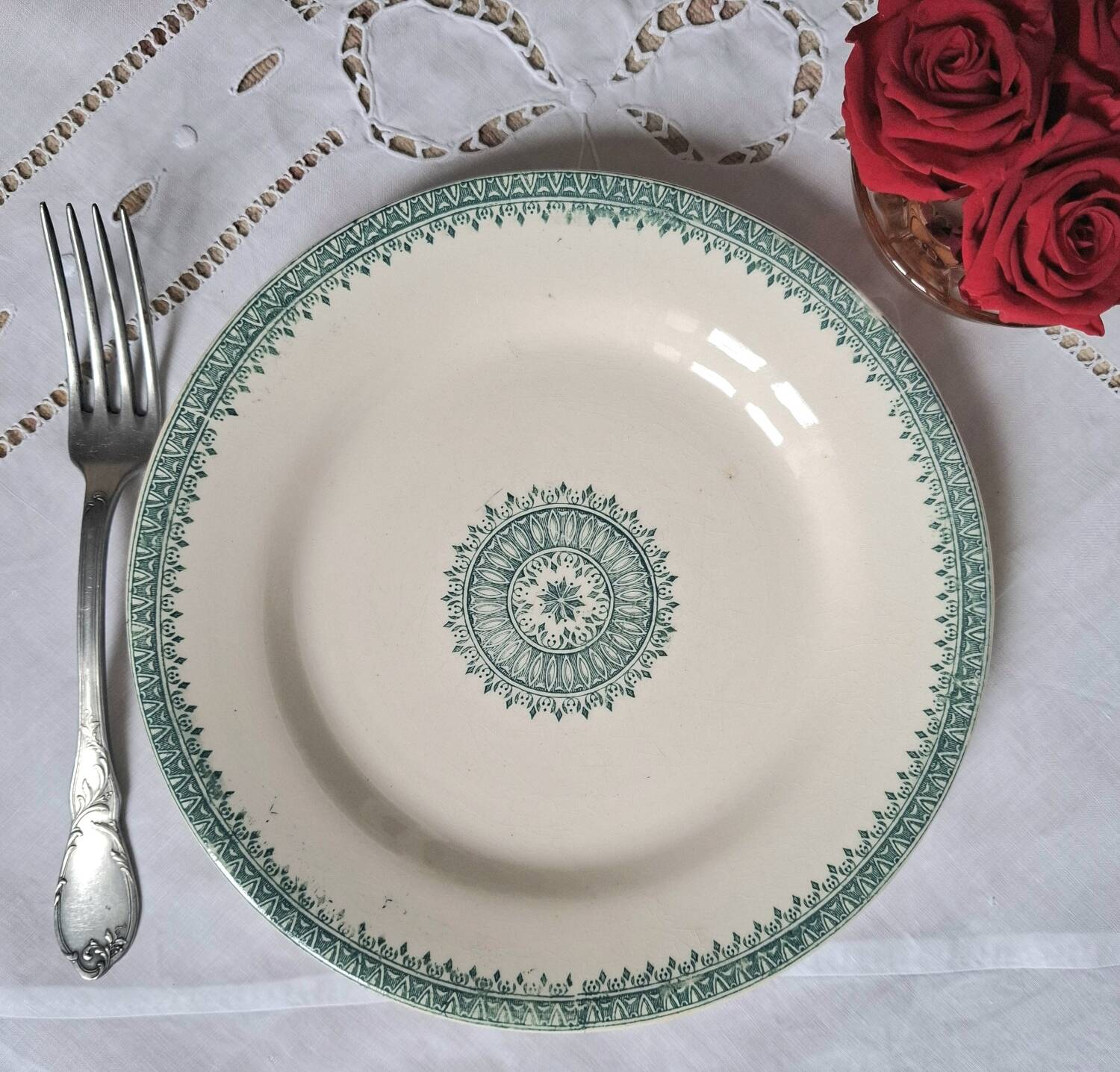 Old mismatched flat plates in iron earth earthenware accompanied by a dish