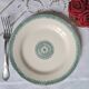 Old mismatched flat plates in iron earth earthenware accompanied by a dish