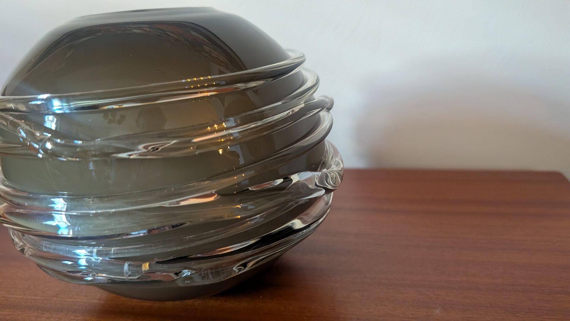 Smoky glass spherical vase with spiral applications from the 1970s.
