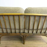 Two-seater rattan sofa with natural tones