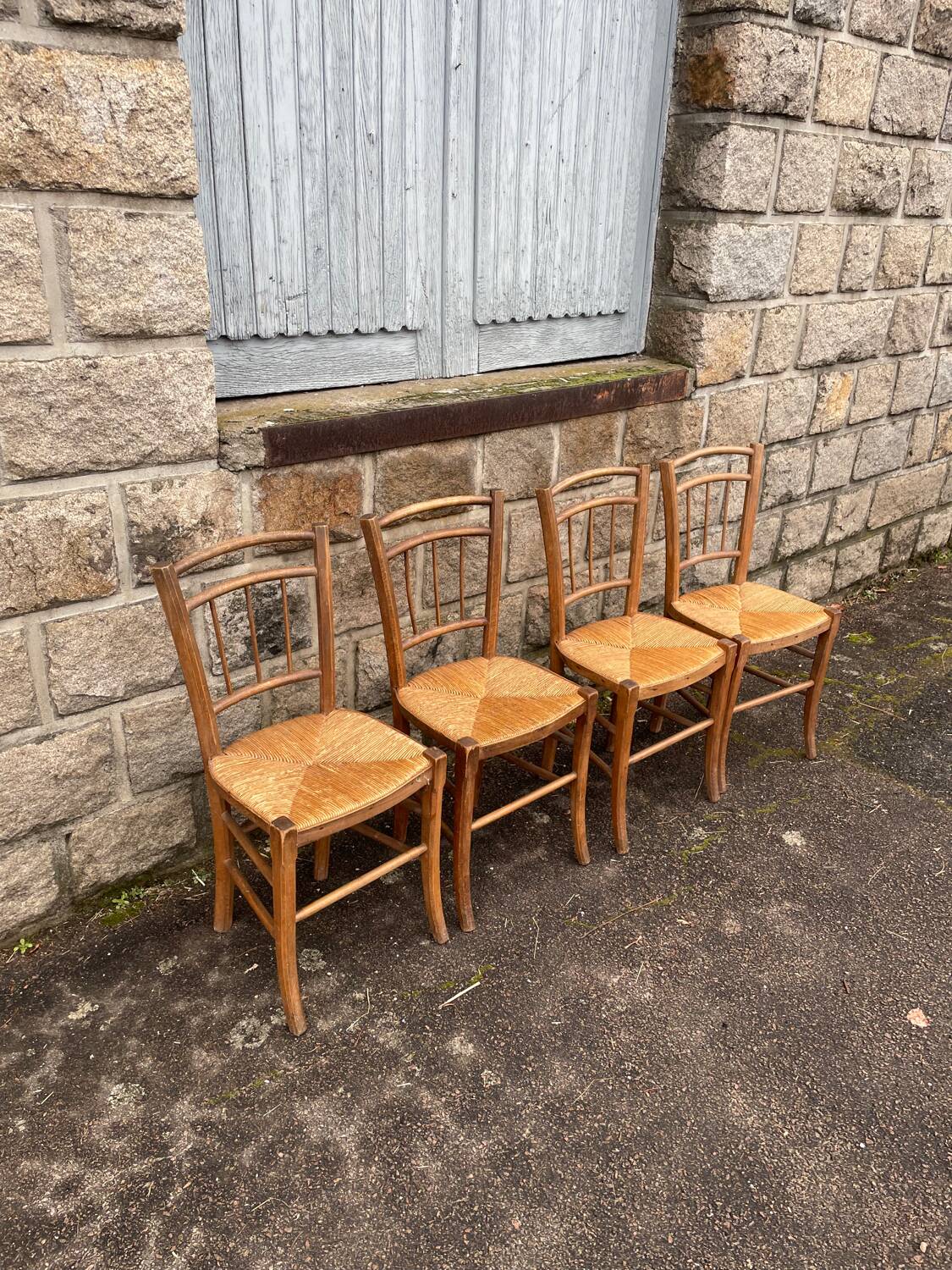 four vintage bistro-style straw chairs