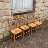 four vintage bistro-style straw chairs