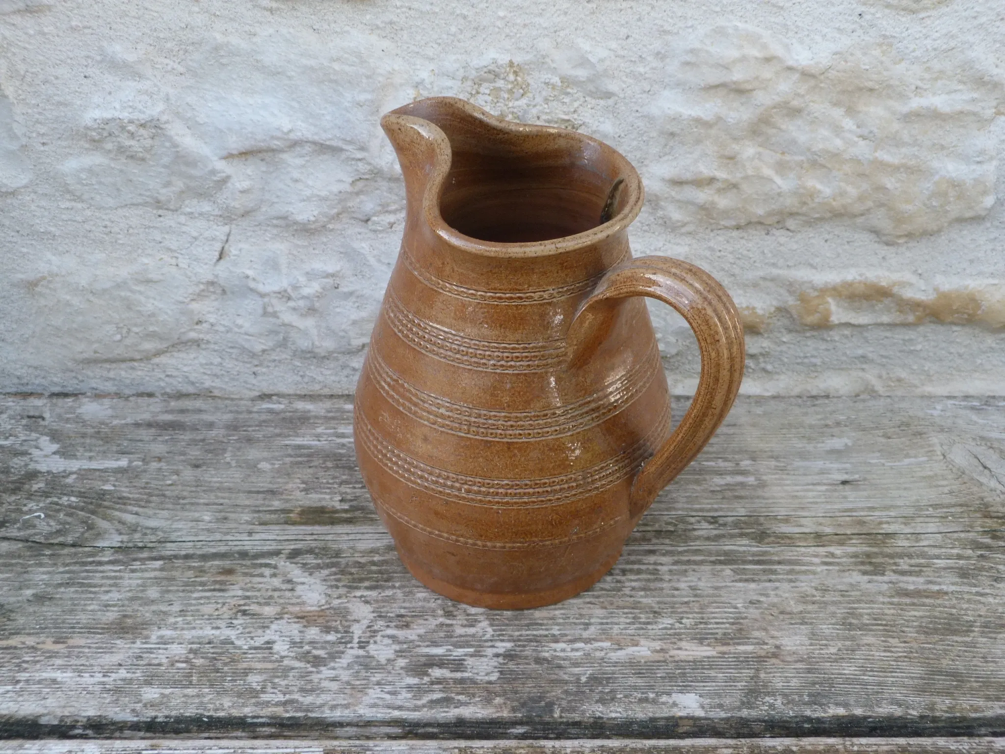 Old stoneware wine jug with patterns