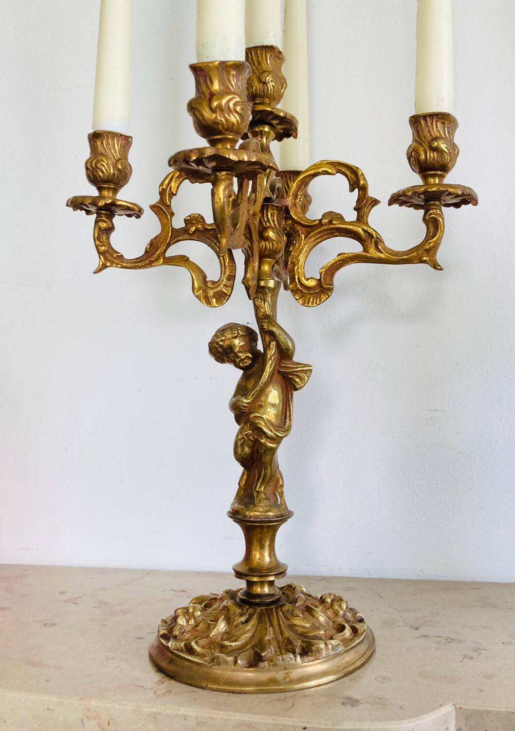 Solid bronze candlesticks decorated with putti, acanthus leaves and lion heads