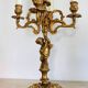 Solid bronze candlesticks decorated with putti, acanthus leaves and lion heads
