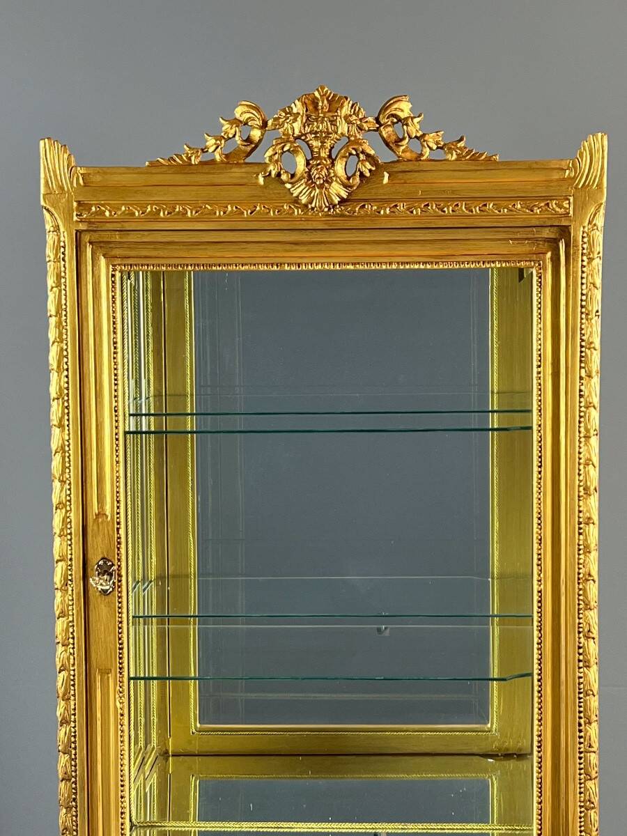 Carved and gilded wooden display cabinet, Louis XVI style, 20th century.