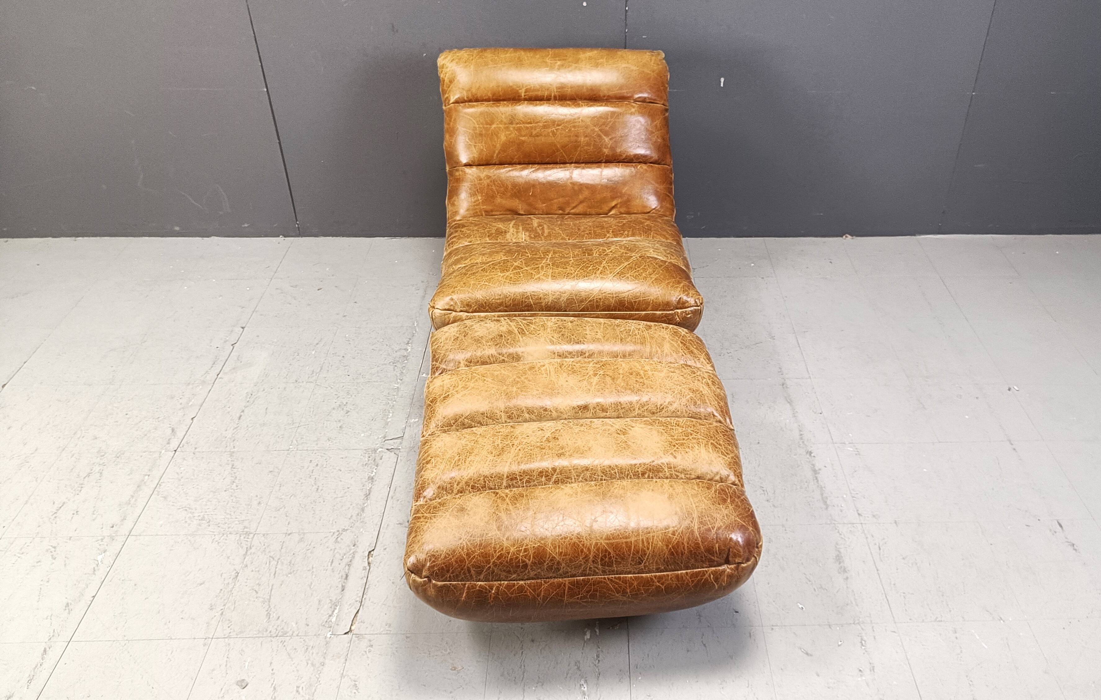 Vintage leather swivel chair with stool, 1970s