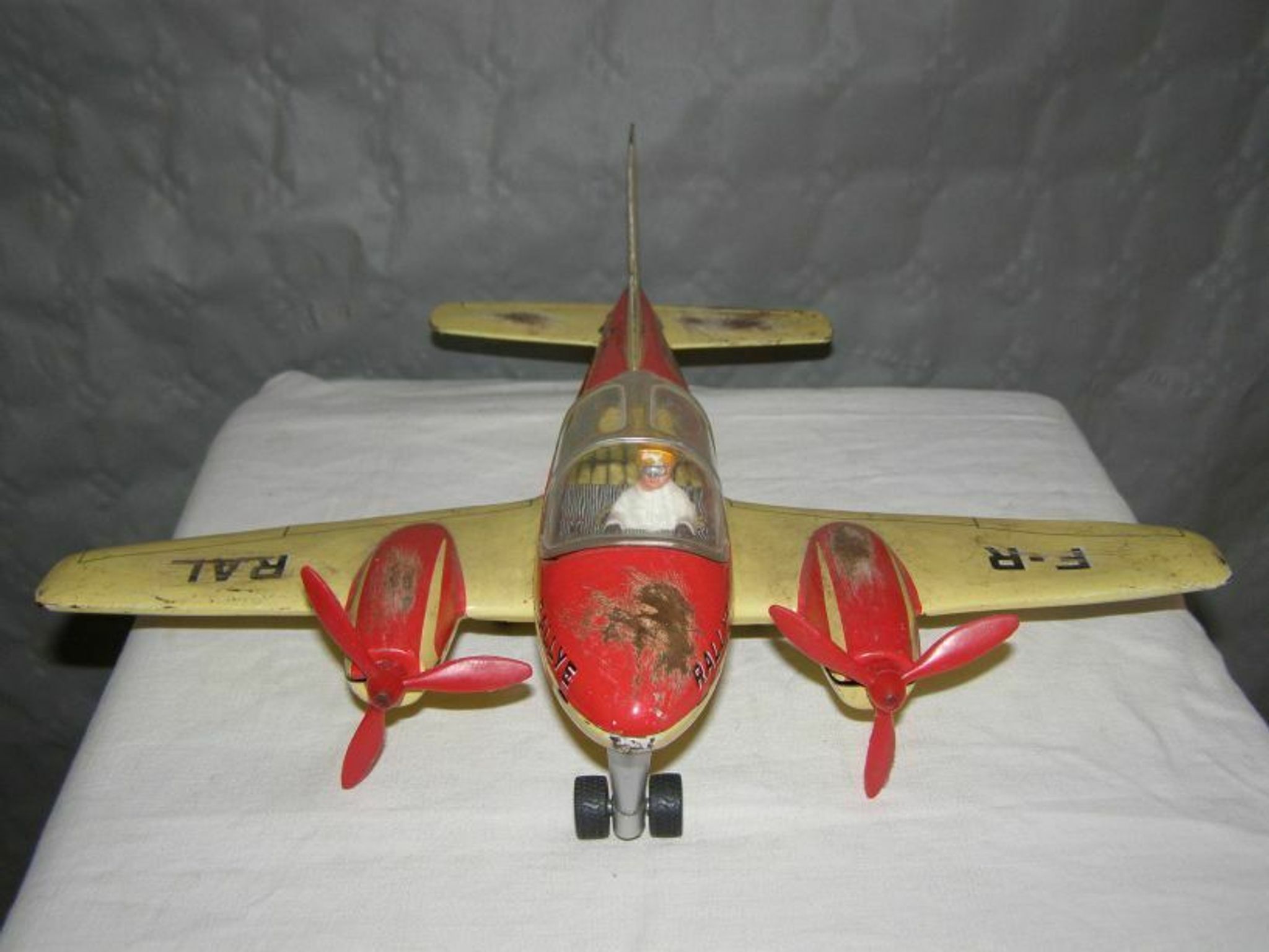 Old metal Joustra toy; propeller aircraft with its pilot friction mechanism