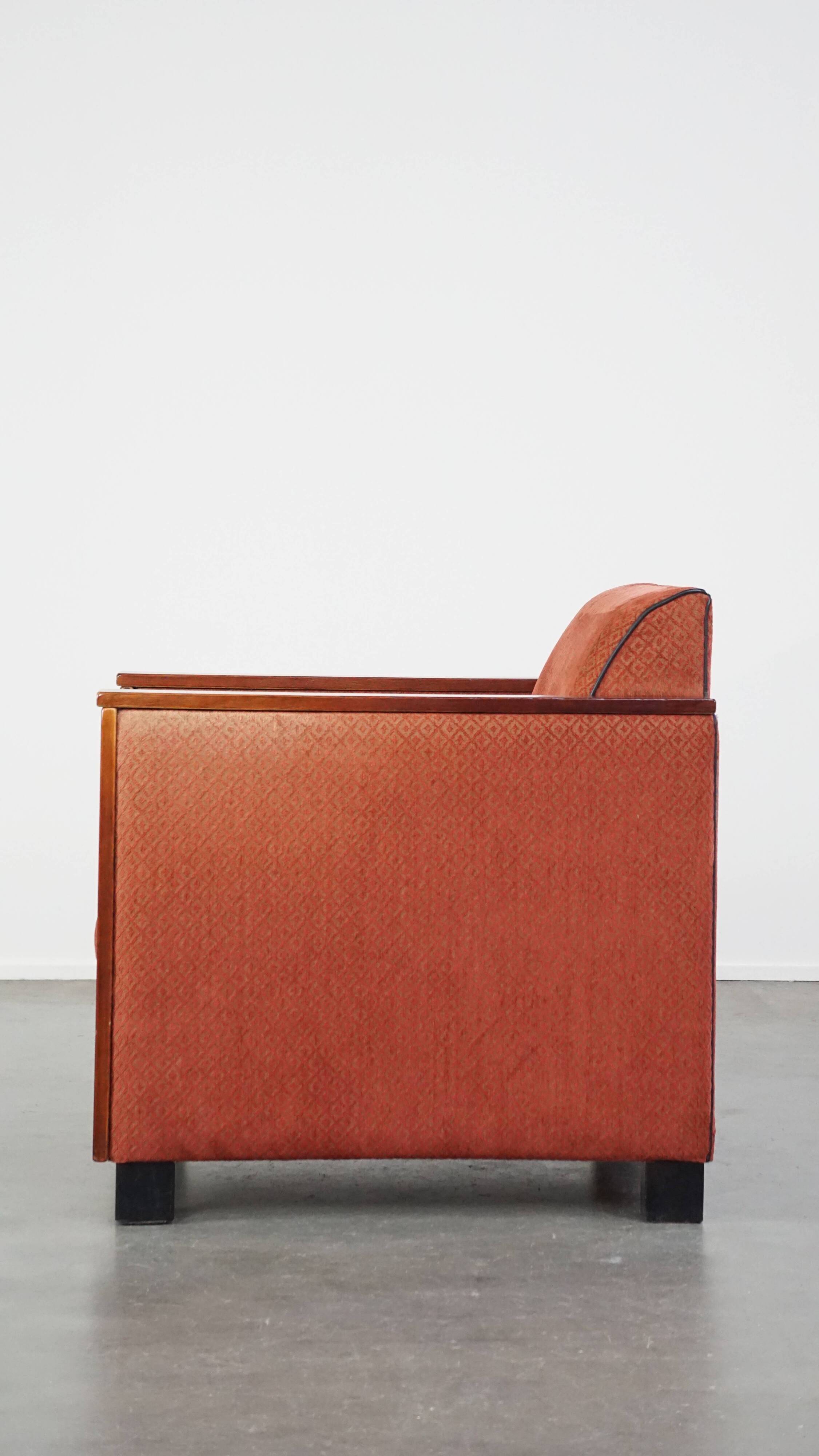 Art Deco design armchair with red fabric upholstery and wooden details