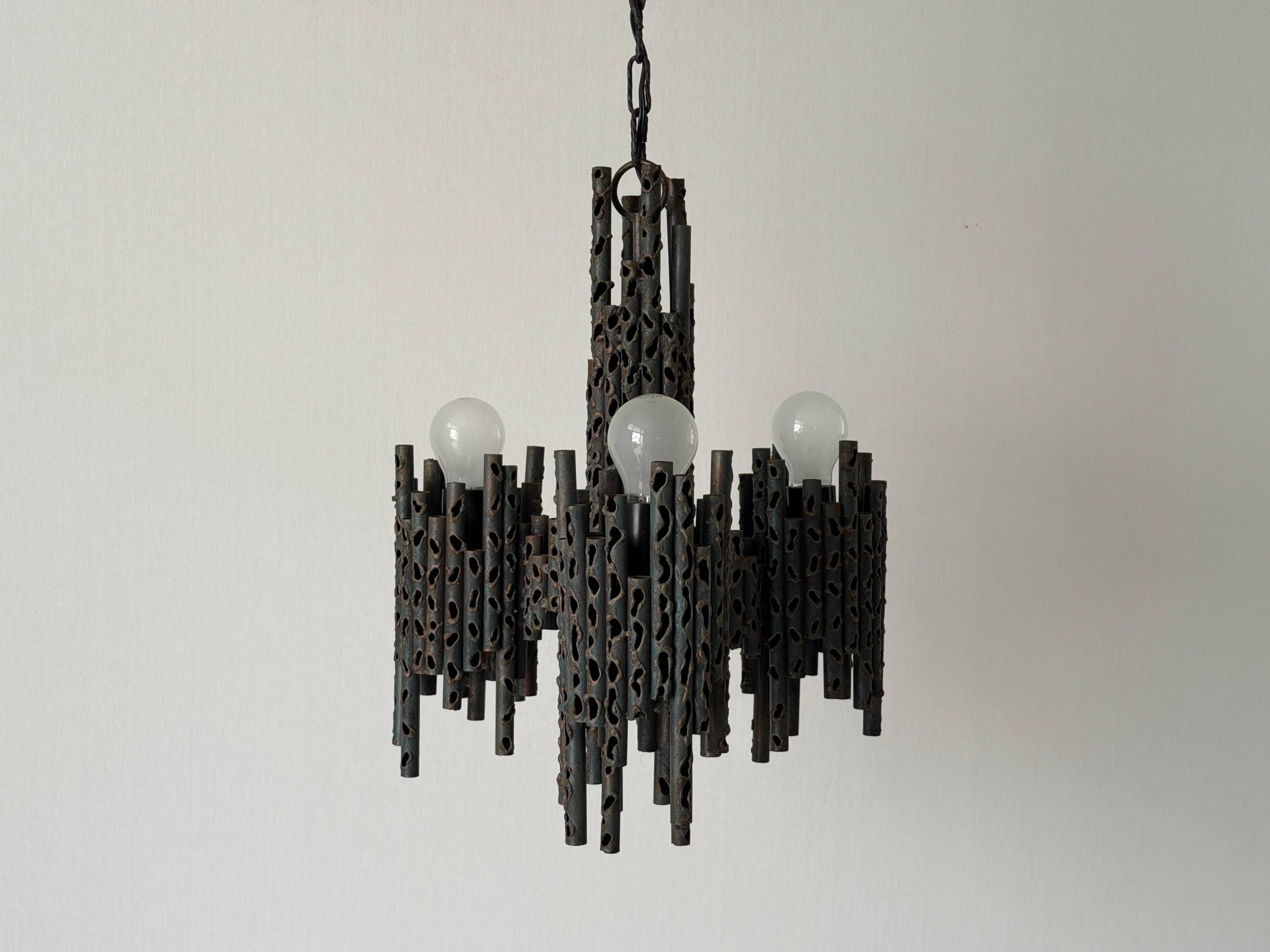 Three-armed suspended lamp in wrought iron, brutalist design, 1960s, Italy.