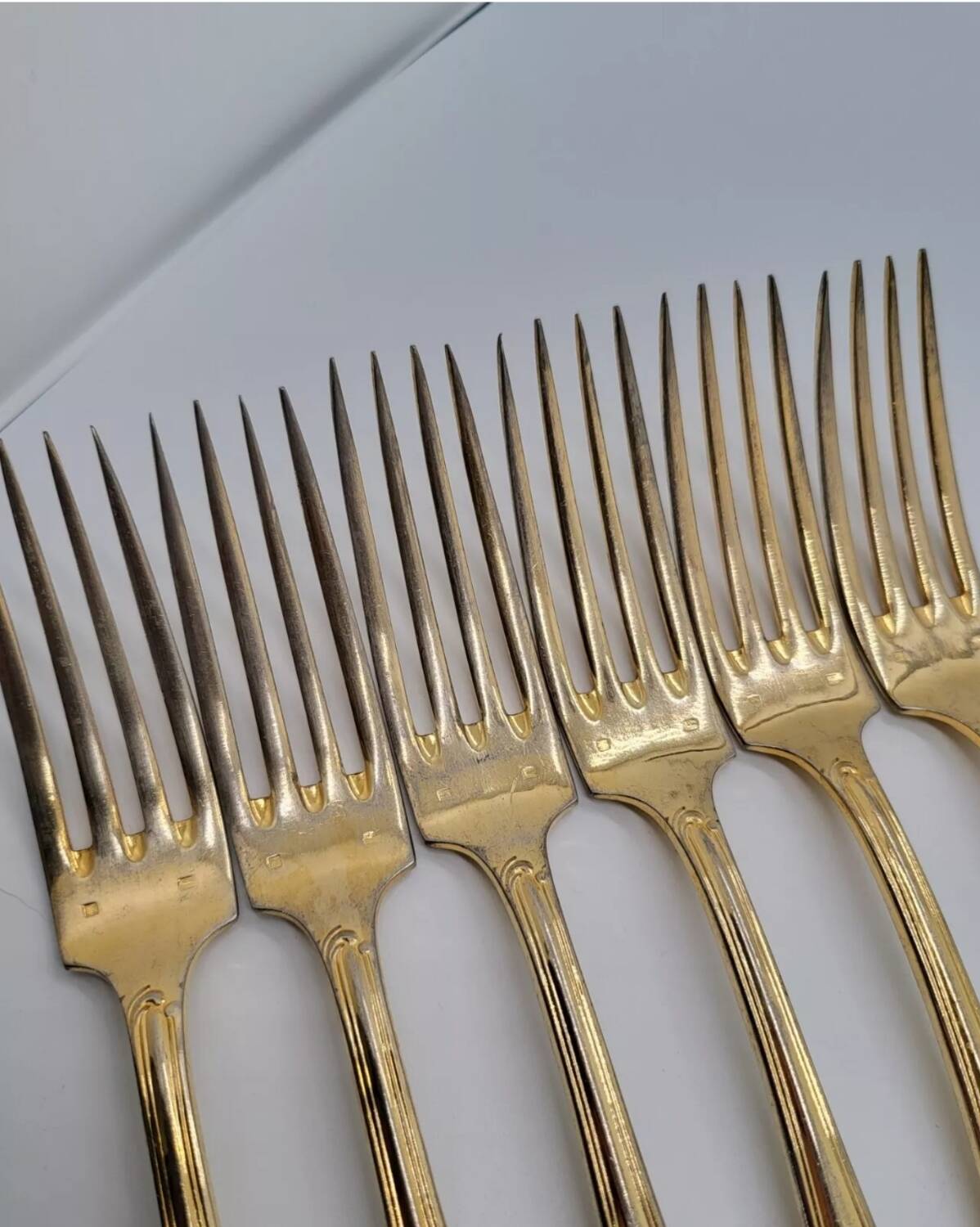 12 Table Forks in gold metal