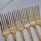 12 Table Forks in gold metal