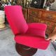 Old cinema chair with a red reclining seat.