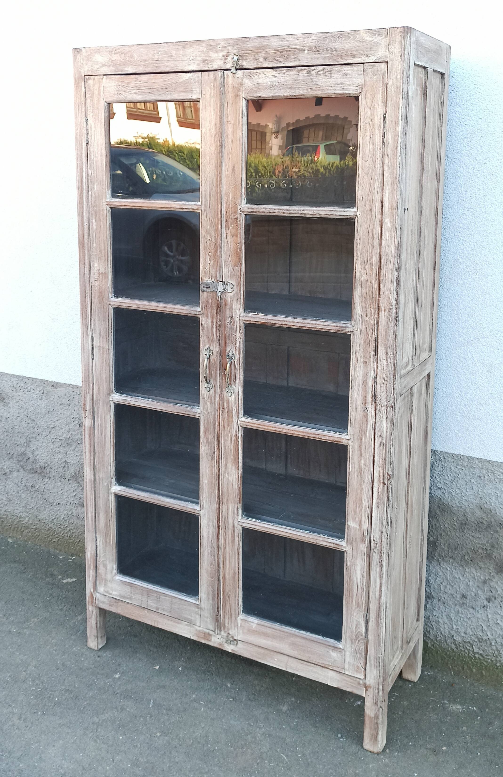 Glass cabinet in old whitewashed wood