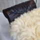 Carved wooden stool covered with Celtic-style sheepskin
