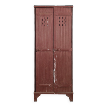 Red painted metal workshop locker with two doors.