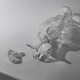 Vintage pressed glass carafe from the 1960s, clear sculptural glass with textured patterns and a stopper.