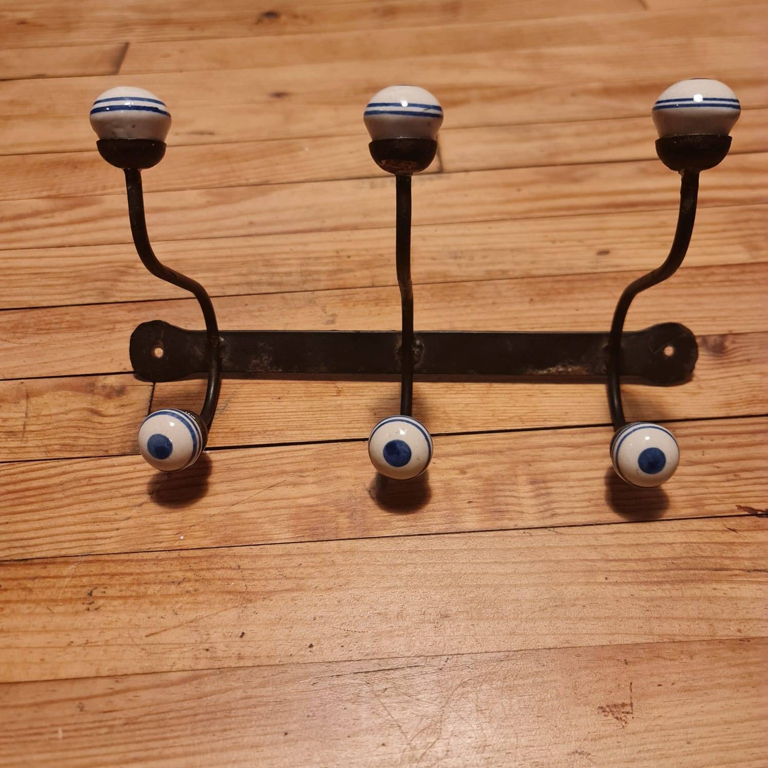 Old iron and porcelain coat hooks