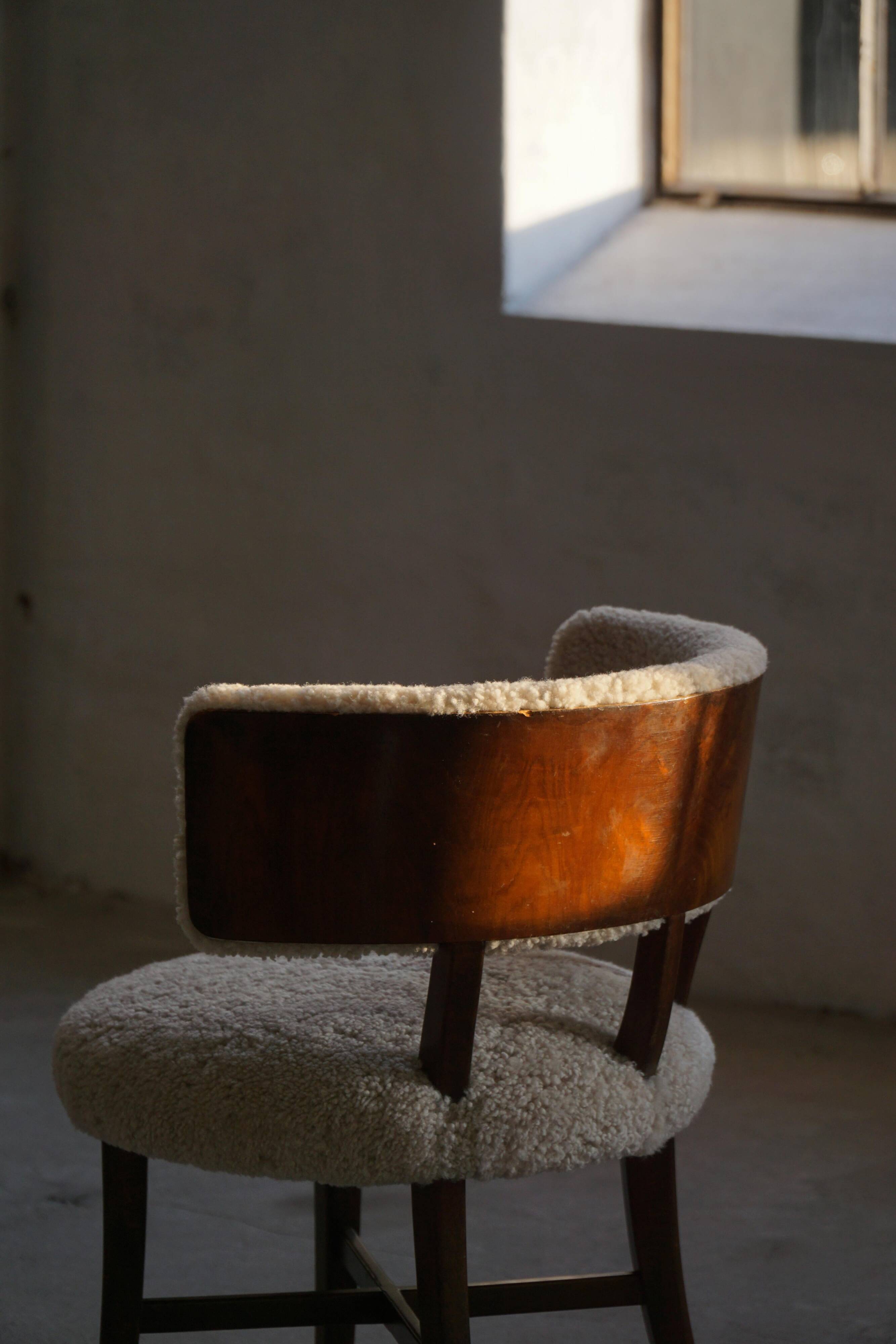 A modern Danish elegant low-back chair, reupholstered in lambswool, 1940s.