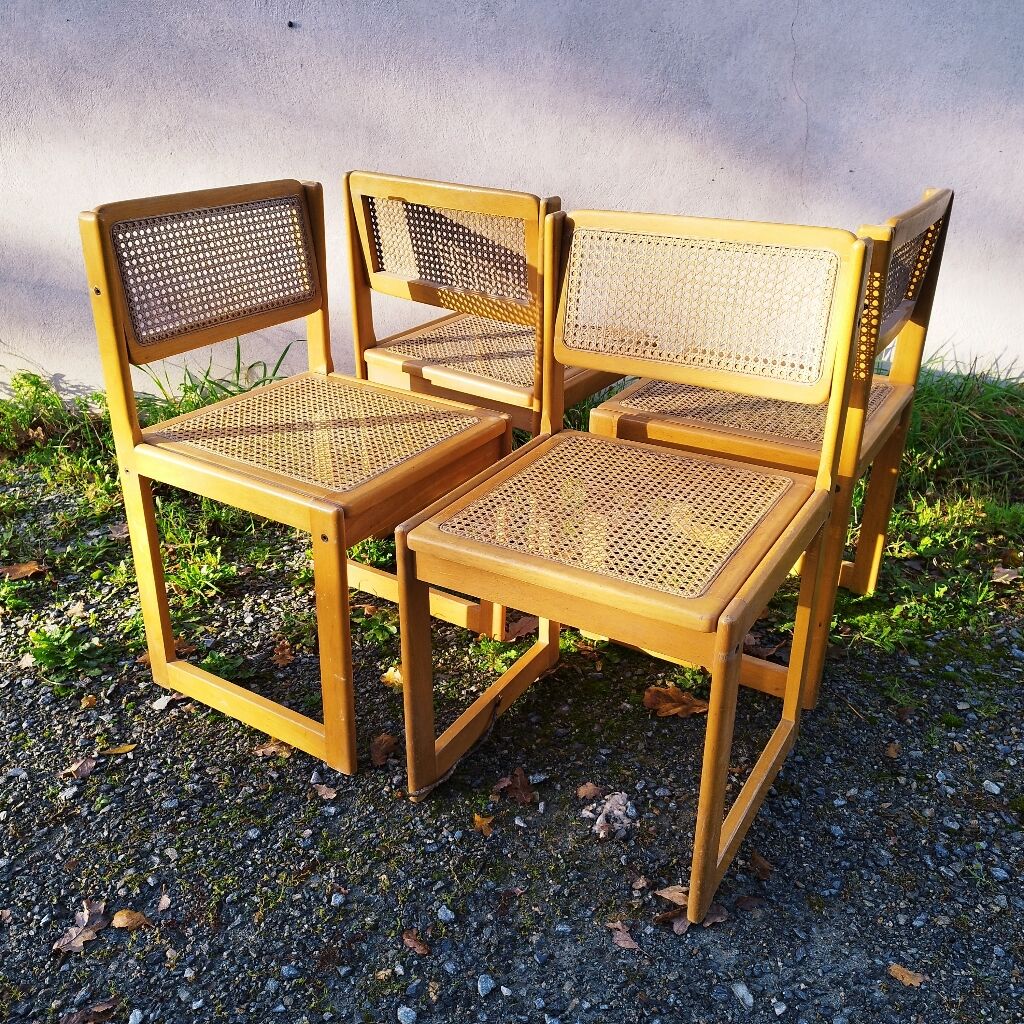 Four trendy tanned wooden chairs