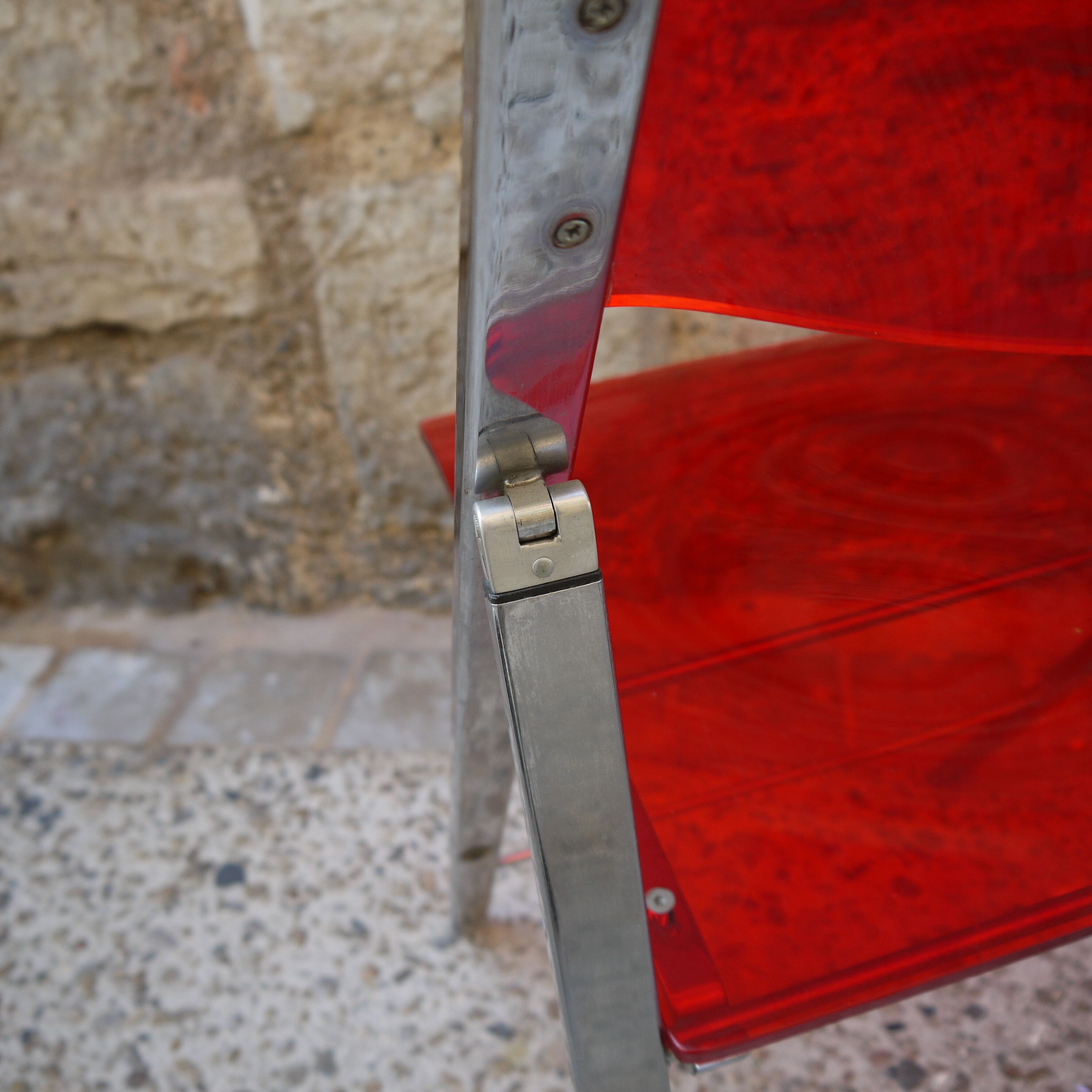 Red Plexiglas folding chair