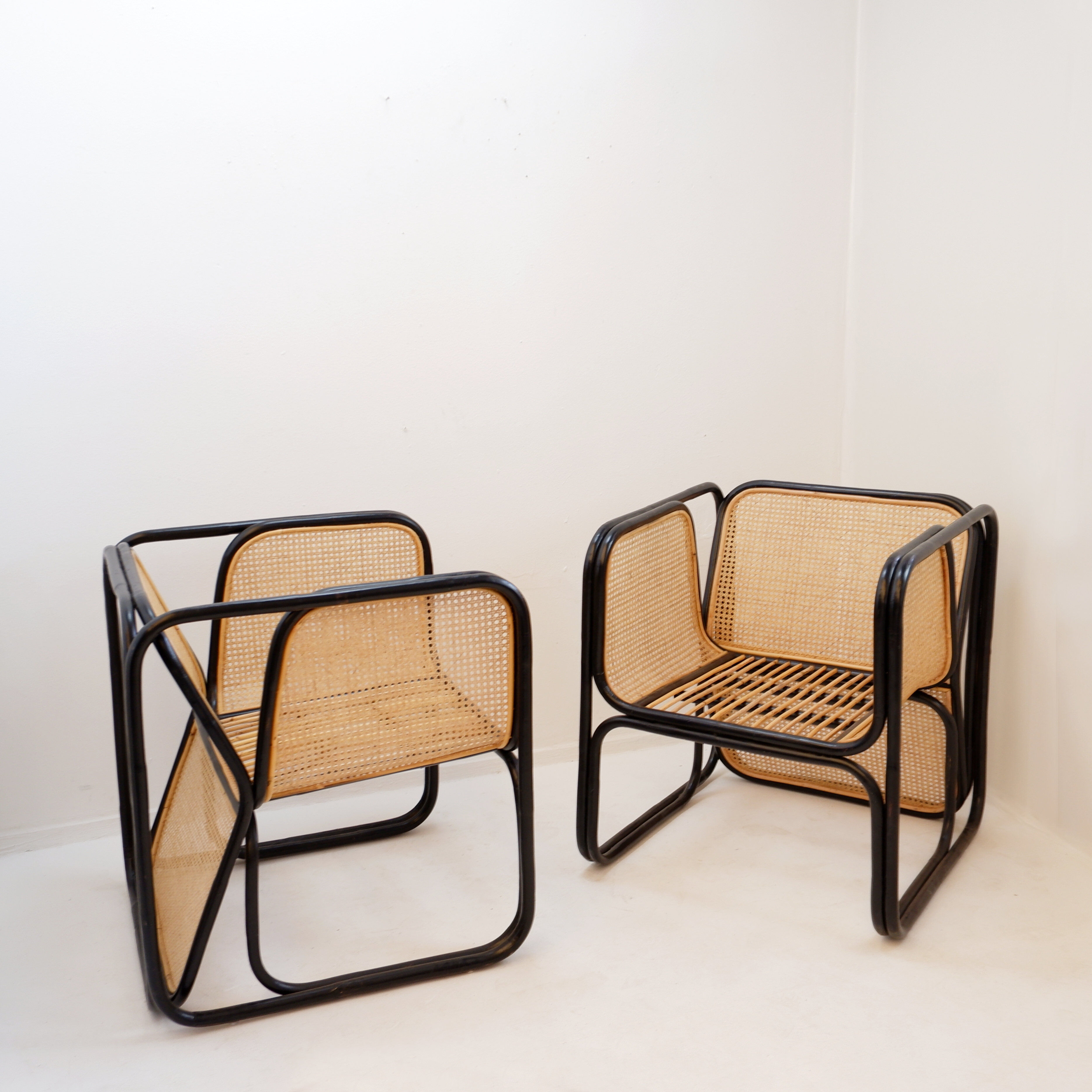 Pair of designer armchairs in curved wood and wicker