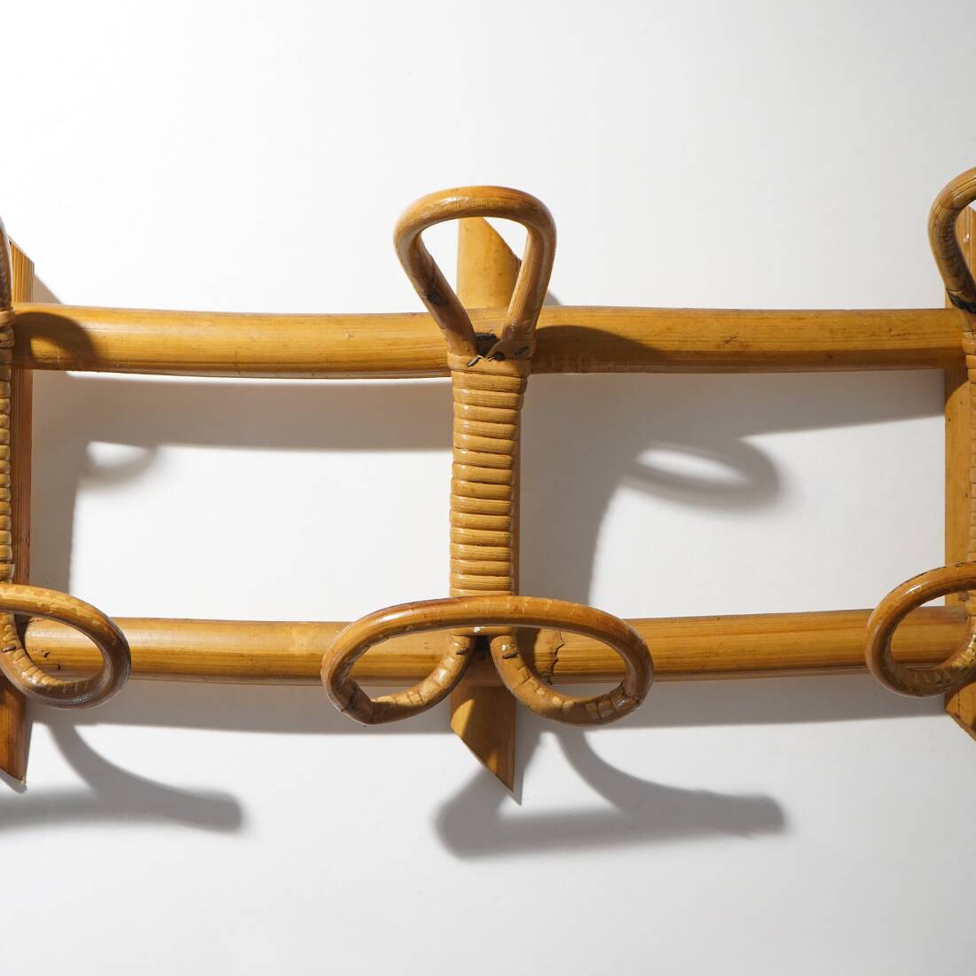 Wall coat rack in rattan and woven wicker, 1960s.