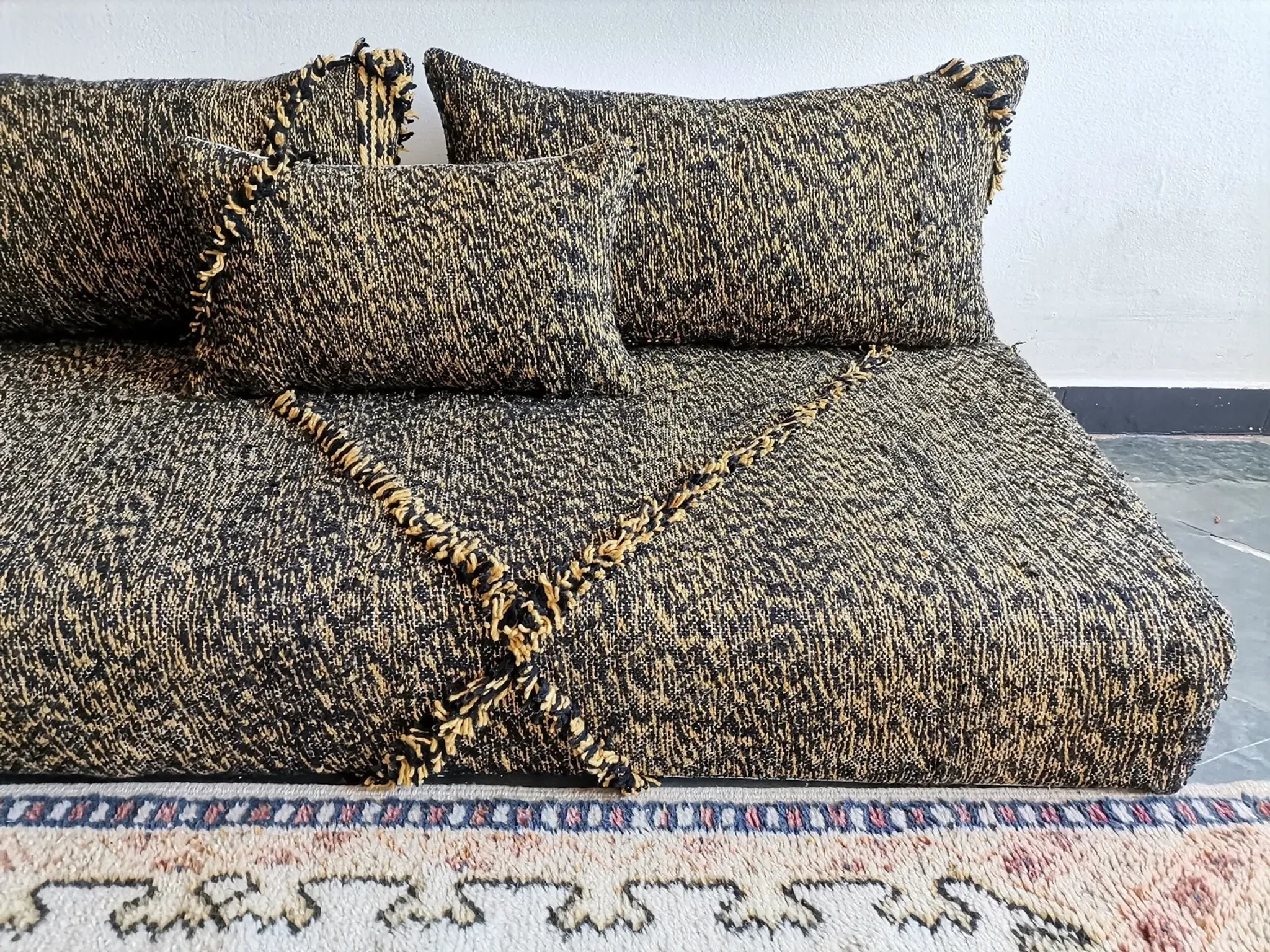 Moroccan sofa on the floor – black and gold pattern