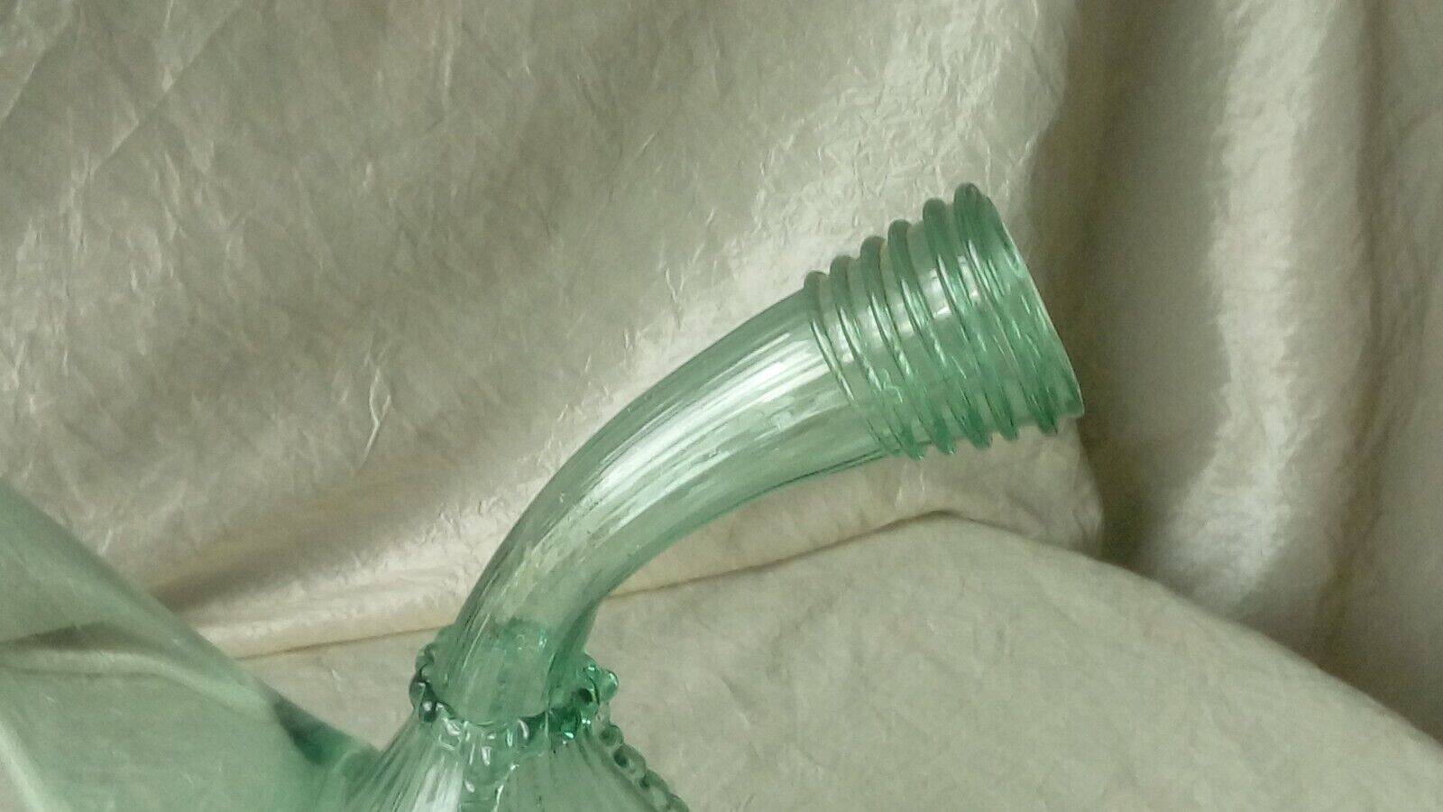 Blown glass carafe with a goat design.