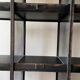 Black metal shelf with compartments.