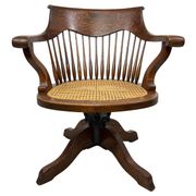 Swivel office chair in oak with a rattan seat.