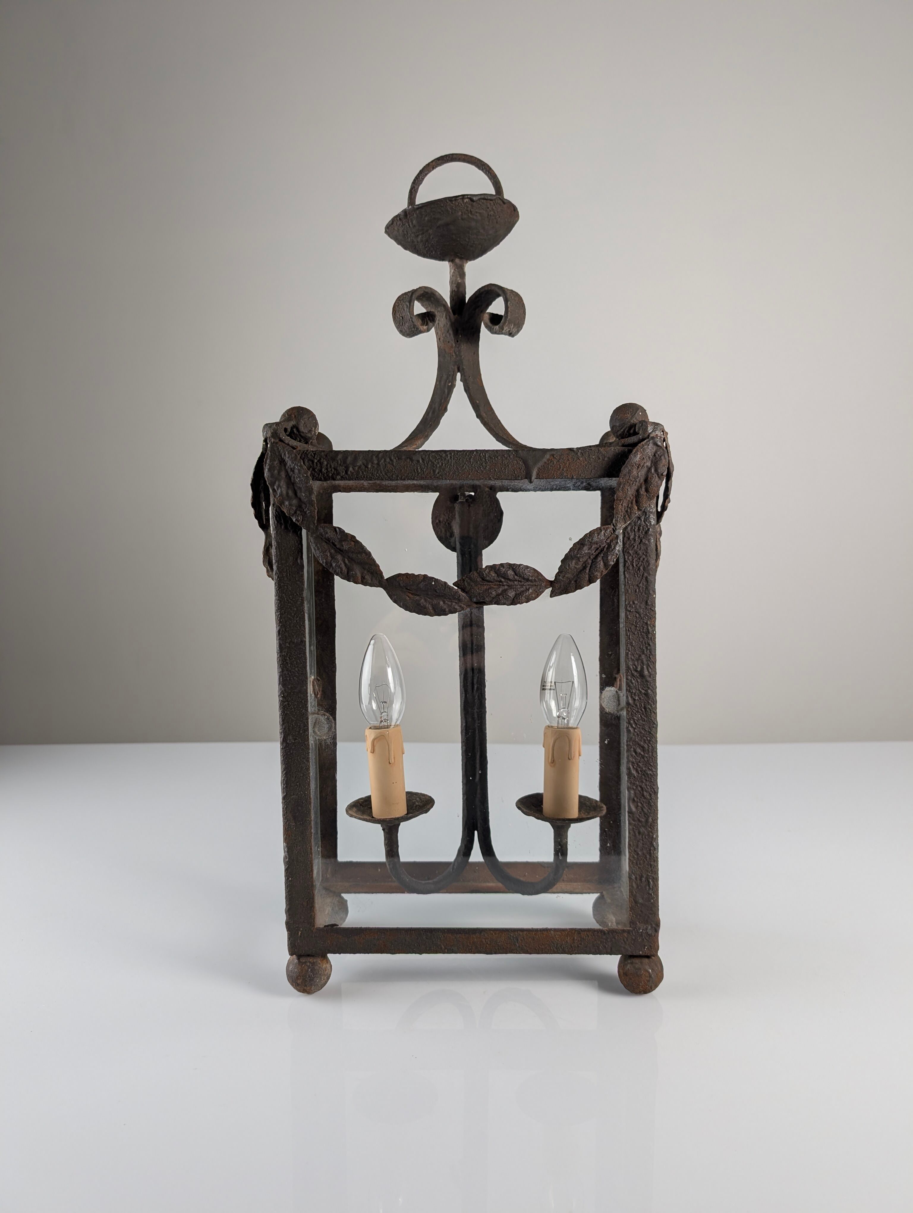 Wrought iron lantern with glass panels, leaf motifs