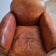 Patinated leather club armchair