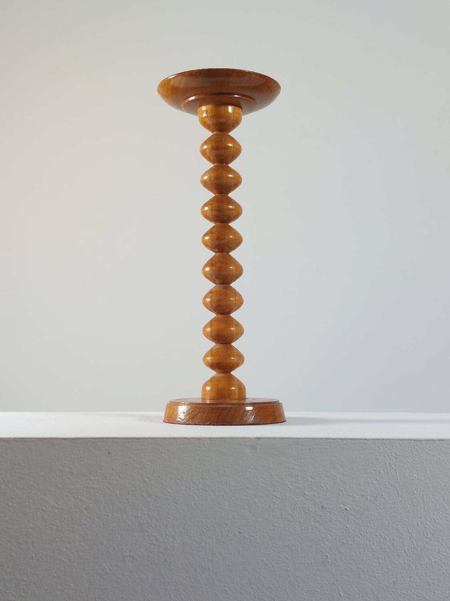 Vintage mid-century wooden candlestick, spool decoration from the 1970s.