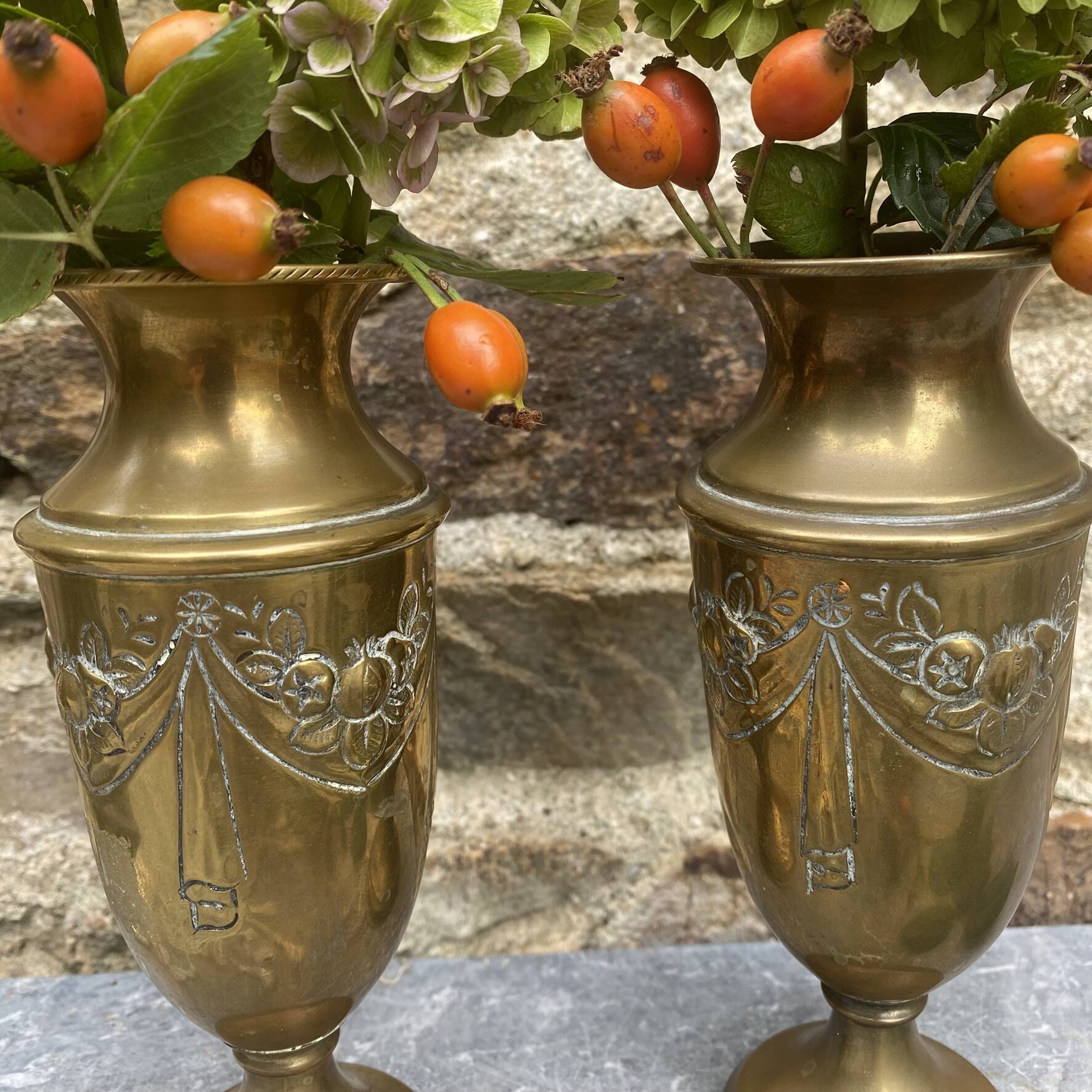 Pair of embossed brass bud vases stamped 17 cm